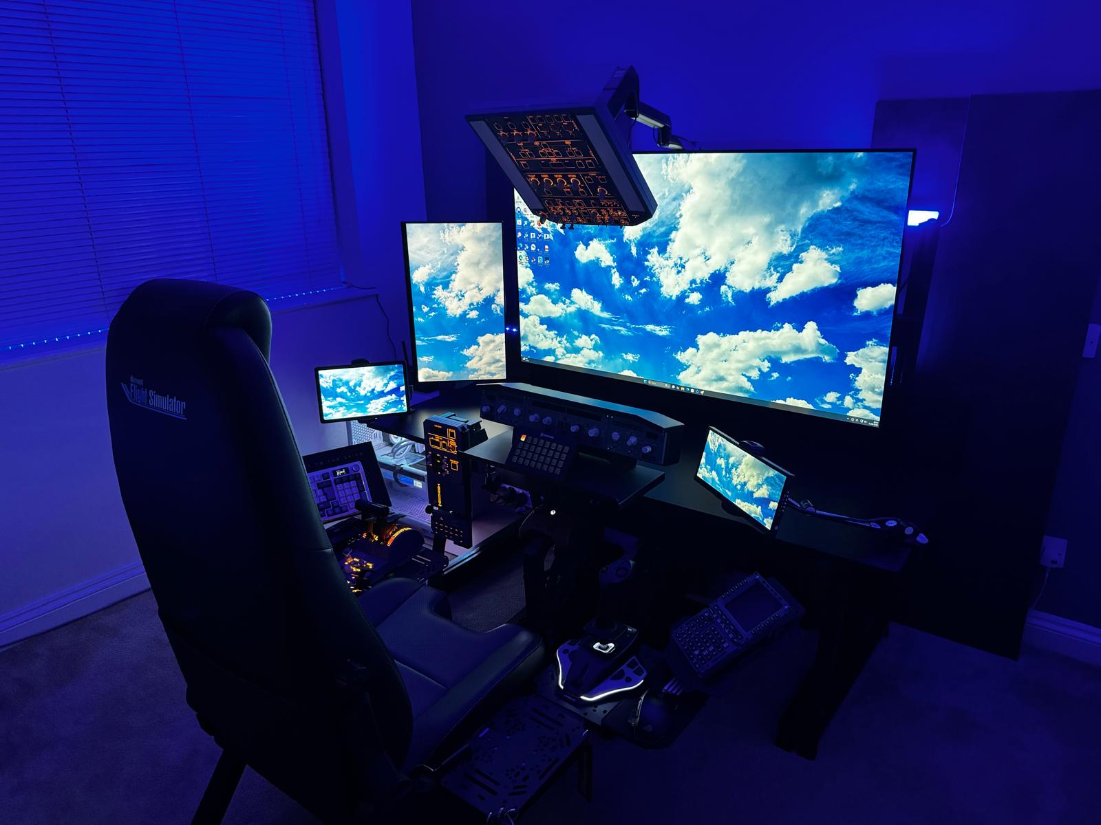 Airbus-style home flight simulator setup with multiple screens, cockpit controls and overhead panel