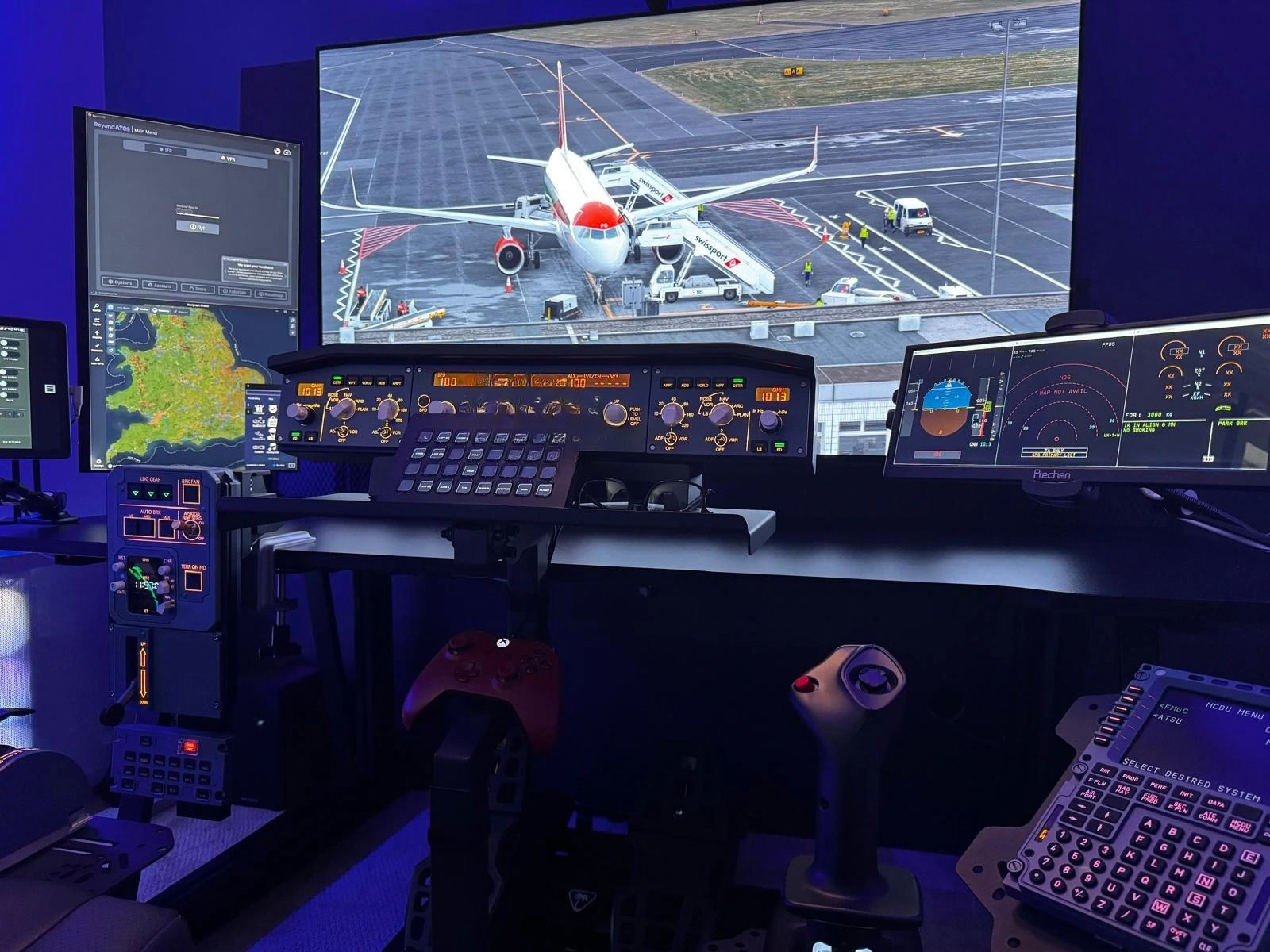 Advanced home flight simulator setup with multiple screens showing an aircraft at an airport, navigation displays and realistic cockpit controls.